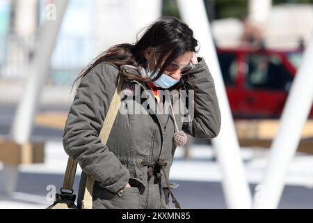 Die Bilder zeigen Bürger, die aufgrund des starken Bura-Windes, der seit dem frühen Morgen weht, Schals und Hüte tragen., in Sibenik, Kroatien, am 23. März 2021. Foto: Dusko Jaramaz/PIXSELL Stockfoto