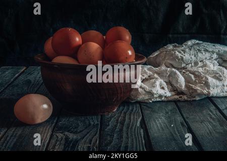 Hühnereier auf einem Tonteller auf dem Tisch Stockfoto