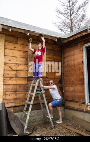 Union Beach, N.J., 24. Juli 2013 Freiwillige aus der King Street United Brethren Church reißen beschädigtes Holz aus einem Hurrikan heraus, den Sandy im Rahmen des Verfahrens zur Beseitigung von Trümmern vor der Erhebung zerschlagen hat. Hurrikan Sandy Aus New Jersey. Fotos zu Katastrophen- und Notfallmanagementprogrammen, Aktivitäten und Beamten Stockfoto
