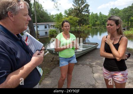 Grand Ridge, Florida, 12. Mai 2014 während einer Schadensbeurteilung in Jackson County, Florida, Mitglied des State Emergency Response Team (SERT) hört Alvin Bishop Theresa Thorpe und Brandy Dudley über ihre Hochwassererfahrungen. Sintflutartiger Regen durch ein Paar Gewitter löste große Überschwemmungen an Teilen des Florida Panhandle aus. Andrea Booher/FEMA. Schwere Stürme, Tornados, Stürme und Überschwemmungen in Florida. Fotos zu Katastrophen- und Notfallmanagementprogrammen, Aktivitäten und Beamten Stockfoto