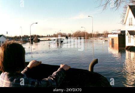 Schwere Stürme/Überschwemmungen, East Grand Forks, MN, 04/18/97 Ein Bewohner beobachtet, wie ein Lastwagen der Nationalgarde durch die Straßen von East Grand Forks fährt und die Bewohner evakuiert, während das Hochwasser aufsteigt. .. Fotos zu Katastrophen- und Notfallmanagementprogrammen, Aktivitäten und Beamten Stockfoto