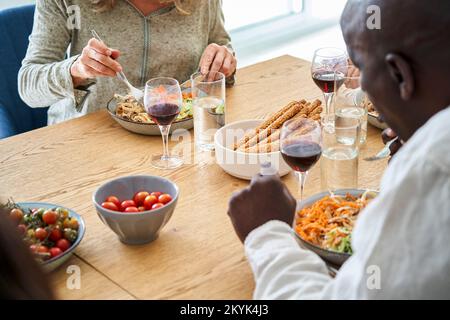 Rear shot of African-American man having a meal with friends Stock Photo