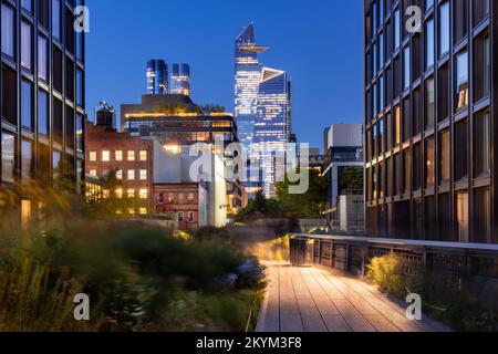 New York City Highline Promenade in Chelsea. Hochglanz mit Hudson Yards Wolkenkratzern am Abend. Manhattan Stockfoto