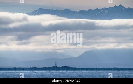 Race Rocks Lighthouse in der Juan de Fuca Strait südwestlich von Victoria, British Columbia, Kanada, mit den Olympischen Bergen im Hintergrund. Stockfoto