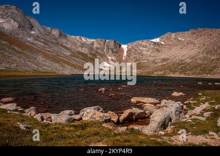 Die felsige zerklüftete Küste des Summit Lake am Mount Evans, Colorado, unter dem Sommerhimmel. Stockfoto