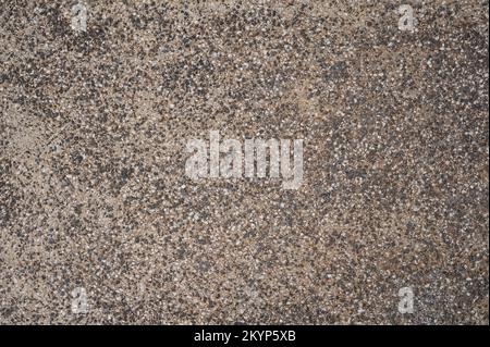 Struktur von kleinem Gestein auf Sand, Nahaufnahme des Hintergrunds Stockfoto