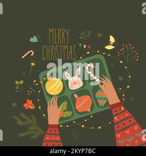 „Merry Christmas“-Karte mit Händen, die Weihnachtsdekorationen tragen Stock Vektor