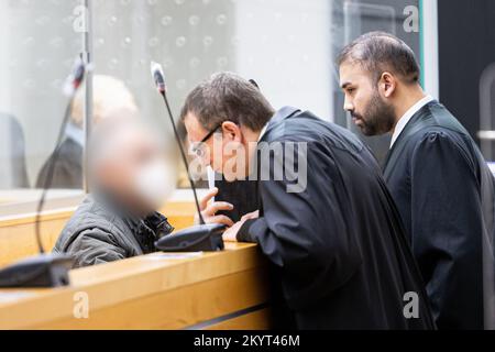 Hannover, Deutschland. 02.. Dezember 2022. Der Beklagte (l) sitzt zu Beginn des Prozesses in einem Raum des Regionalgerichts Hannover und spricht mit seinen Verteidigern Nils Ludewig (2. von links) und Harun Duran (r), bevor der Prozess beginnt. Der Angeklagte wird beschuldigt, seine Frau im Juni 2022 in Hannover mit einem Küchenmesser erstochen und getötet zu haben. Der Angeklagte hat dann angeblich einen Polizisten erstochen, den er selbst gerufen hatte. Kredit: Michael Matthey/dpa - ACHTUNG: Person(en) wurde(n) aus rechtlichen Gründen/dpa/Alamy Live News verpixelt Stockfoto