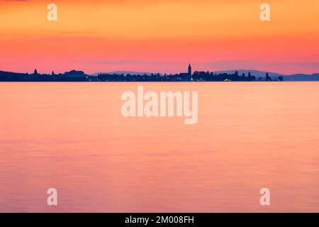Kirche und Hafen von Romanshorn im Abendlicht, Blick von Arbon über den Bodensee Stockfoto