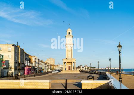 Die verlassene zentrale Parade, Promenade und der Uhrenturm an der Herne Bay Küste in Kent, um 6 Uhr an einem Sommermorgen unter klarem blauen Himmel Stockfoto