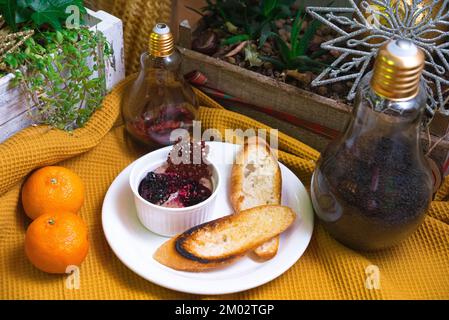 Schokoladenmousse mit Johannisbeermarmelade, zwei Scheiben getoastetes Brot Stockfoto