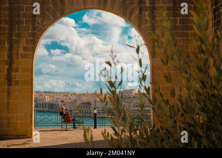 Blick vom Mausoleum in den Barakka-Gärten in Valletta, Malta an einem wunderschönen Sommertag. Malerische antike Häuser und Festung auf der anderen Seite der Bucht. Stockfoto