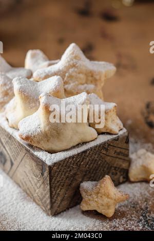 Hausgemachte Plätzchen in Sternform mit Puderzucker in Holzbox Stockfoto