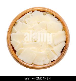 Grana Padano Käseflocken, in einer Holzschüssel. Italienischer Hartkäse, ähnlich wie Parmesan, krümelig strukturiert, mit kräftigem herzhaftem Geschmack und grober Textur. Stockfoto