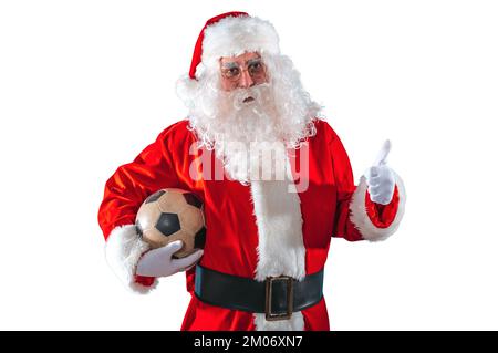 Positiver weihnachtsmann mit Football-Ball in der Hand Stockfoto