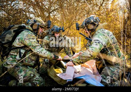 U.S. Air Force tactical air control party specialists from the 169th Air Support Operations Squadron, Illinois Air National Guard, perform medical aid to a medical mannequin during Exercise Forward Reach 23-1 in Danvers, Illinois, Dec. 3, 2022. The TACPs used the exercise to demonstrate their new Mobile Response Team domestic operations capability, which will quickly extend the reach of first responders during natural disasters. (U.S. Air National Guard photo by Staff Sgt. Wynndermere Shaw) Stockfoto