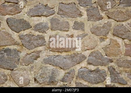 Alte Steinmauer, Nahaufnahme. Hintergrundtextur. Stockfoto