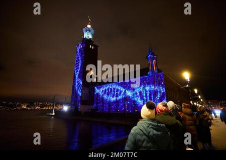 Nobel Week Lights im Zentrum von Stockholm, wo unter anderem das Arbeitsbewusstsein auf das Stockholmer Rathaus, Schweden, am 3. Dezember 2022 projiziert wird. P Stockfoto