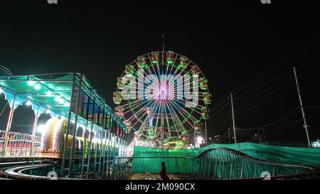 Riesenrad mit grüner Beleuchtung auf einer Ausstellung der indianer bei Nacht Stockfoto