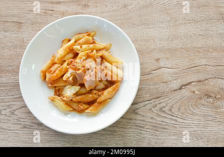 penne Pasta-Belag Schweinefleisch bologna Dressing gebratenes Schweinefleisch in Ketchup und Käsesauce auf dem Teller Stockfoto