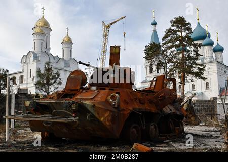 Swjatohirsk, Ukraine. 30.. November 2022. Ein zerstörter russischer Flugzeugträger steht im Hof eines Privathauses vor einem orthodoxen Tempel in der befreiten Stadt Sviatohirsk. Russland verliert täglich zwischen 50 und 100 Soldaten in der Schlacht von Bakhmut inmitten seiner verzweifelten Versuche, die Stadt in der Oblast Donezk zu erobern, sagte ein militärischer Sprecher am 4. Dezember. Serhiy Cherevaty, Sprecher des Ost-Militärkommandos, sagte im Fernsehen, dass täglich etwa so viele russische Soldaten in der Nähe von Bakhmut verwundet werden. Monatelang hat Russland Truppen und Ausrüstung zusammengestellt, um zu surren Stockfoto