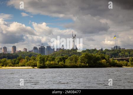 Blick auf die große Stadt auf den Hügeln über dem breiten Fluss bei herrlichem Sonnenuntergang. Sehen Sie das Denkmal Mutter des Mutterlandes und den höchsten Flaggenmast mit großem Nationaldenkmal Stockfoto