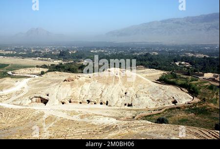 Takht-e Rostam (Takht-e Rustam) ist ein Stupa-Kloster im Norden Afghanistans. Von der Stupa aus auf das Höhlenkloster zu blicken. Stockfoto