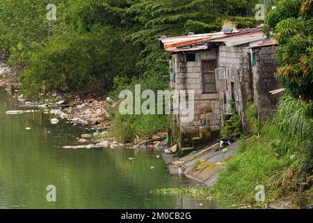 Arme Menschen, die in Armut entlang der Kanäle von Manila Philippinen leben, mit Kopierraum Stockfoto