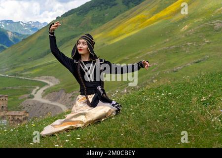 Eine georgische Frau in örtlichen Kostümen, die in Ushguli, Georgia, tanzt. Stockfoto