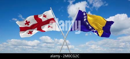 Zwei gekreuzte Flaggen Bosnien und Herzegowina und Georgien winken im Wind am bewölkten Himmel. Beziehungskonzept, Dialog, Reisen zwischen zwei Ländern. Stockfoto