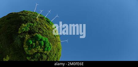 Modell des grünen Planeten Erde aus Moos mit Windturbinen. Symbol für nachhaltige Entwicklung und erneuerbare Energien Stockfoto