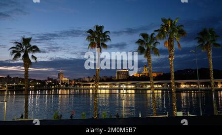 Blick auf Málaga in der Abenddämmerung vom Hafen in Spanien. Stockfoto