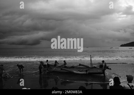 Pangandaran, West Java, Indonesien - 30. Oktober 2022 : Schwarzweißfoto, Schwarzweißfoto von Fischern, die auf einem Boot Fische fangen Stockfoto