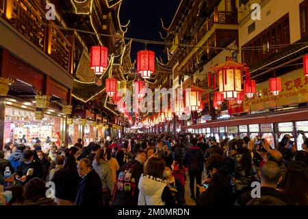 Shanghai, China: Chinesische beleuchtete Laternen hängen auf dem Yuyuan-Basar, während die Menschen die beleuchtete Umgebung während des chinesischen Neujahrs genießen. Stockfoto