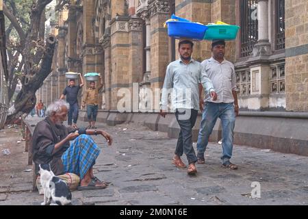 Gepäckträger mit Fischkörben auf dem Kopf, am Chhatrapati Shivaji Maharaj Terminus (CMST) in Mumbai, Indien, um die Körbe mit dem Zug weiterzuleiten Stockfoto