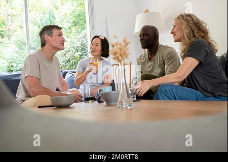 Portrait of diverse group of friends hanging out together at home Stockfoto