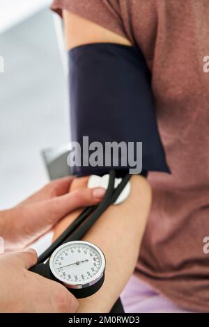 Close-up of person measuring blood pressure Stock Photo