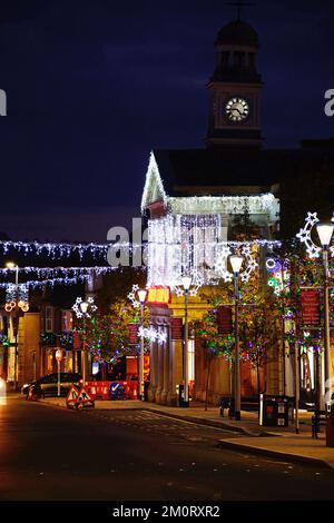 Sehen Sie die High Street und Fore Street mit hübschen Weihnachtsdekorationen bei Nacht, Chard, Somerset, Großbritannien, Europa. Stockfoto