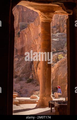 Petra, Jordanien - 3. November 2022: Beduinenmann und Blick vom Garden Temple auf die bunten Felsen am Wadi Farasah Trail Stockfoto