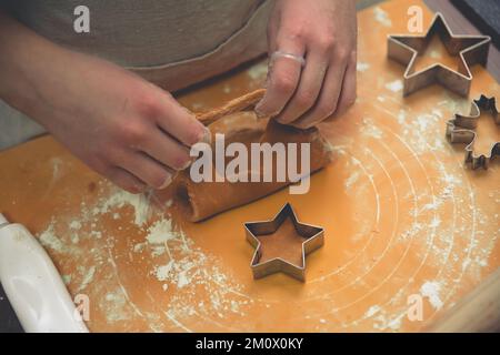 Das Mädchen macht Ingwerkekse mit Weihnachtskeksen. weihnachten, Silvester hausgemacht Stockfoto