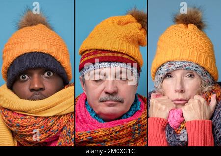 Mann und Frau in mehreren Hüten und Schals, die mit geschlossenen Augen stehen. Stockfoto