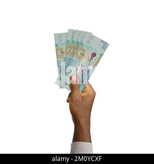 Schwarze Hand mit 3D ausgedruckten Kuwait-Dinar-Noten Stockfoto