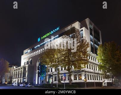 Eriwan, Armenien - 3. Dezember 2022: Hell beleuchtetes Ameriabank Hauptbürogebäude im Zentrum von Eriwan. Kombination aus alter und neuer Architektur Stockfoto