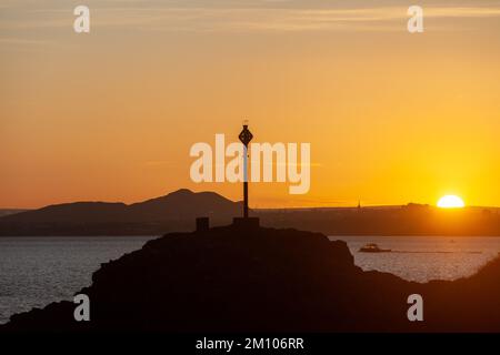 Dalgety Bay, Fife, Schottland. 09. Dezember 2022 Ein kalter Tag in Schottland, erwärmt von einem wunderschönen Sonnenuntergang über Edinburghs Arthur's Seat and Downing Point in Dalgety Bay. © Richard Newton/Alamy Live News Stockfoto