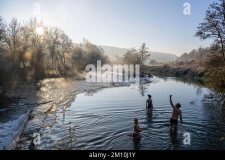 Schwimmer trotzen dem Wasser im Fluss Avon in Warleigh Weir bei Bath in Somerset heute Morgen, als die Temperaturen über Großbritannien sinken. Stockfoto