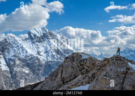 Wengen, hohe Abtei, Provinz Bozen, Südtirol, Italien. Ein Kletterer auf dem Paresberg. Im Hintergrund die Neunerspitze und die Zehnerspitze Stockfoto