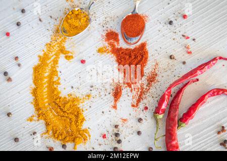 Gefärbte Gewürzpulver, Kurkuma und Paprika, heißer Pfeffer Stockfoto