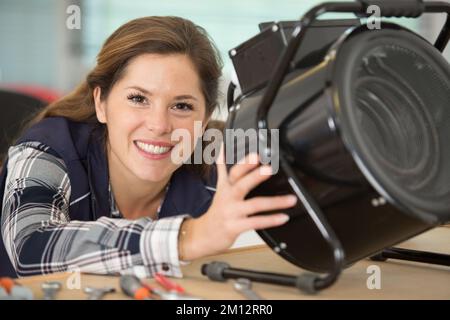 Weibliche Elektrikerin, die am Gerät arbeitet Stockfoto