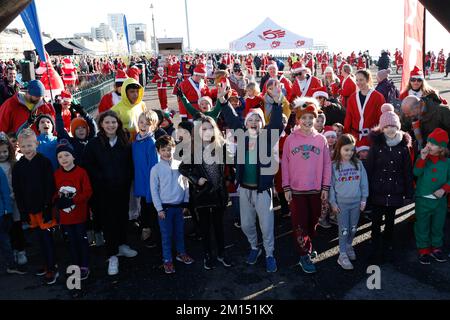 Hove Promenade, Stadt Brighton & Hove, East Sussex, Großbritannien. Der Start des Kinderrennen als Teil der saisonalen Charity-Runs für das Royal Alexandra Children's Hospital in der Stadt Brighton & Hove und auch zur Unterstützung der Kinderheilkunde in Sussex, Großbritannien. Sie sind die ausgewählte Wohltätigkeitsorganisation für Brighton Santa Dash, die von John Gladwin organisiert wird. 10.. Dezember 2022 Kredit: David Smith/Alamy Live News Stockfoto