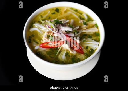 Hühnersuppe im vietnamesischen Stil auf schwarzem Hintergrund Stockfoto